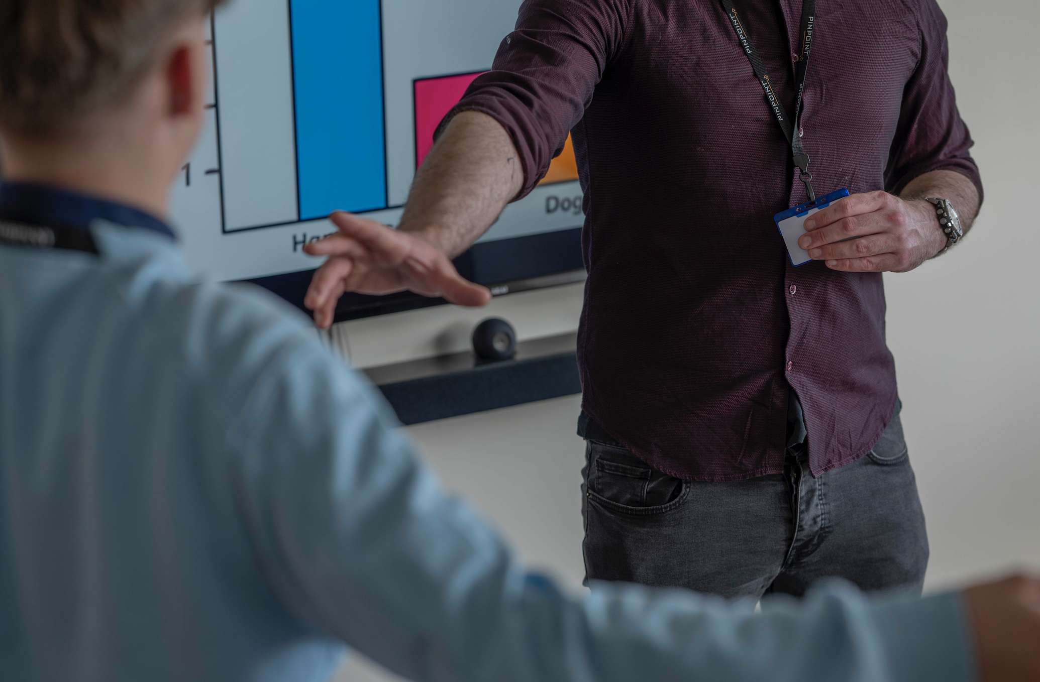 Man activates personal alarm as student waves hands in an aggressive manner